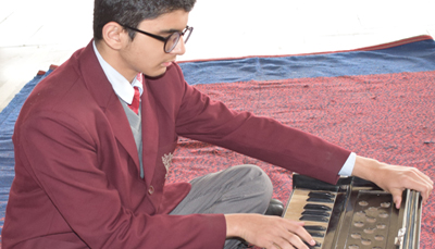 Students practicing keyboard and instrumental music in the school music room